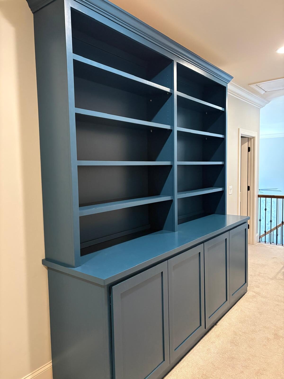 Blue built-in bookcase and hutch with open shelving