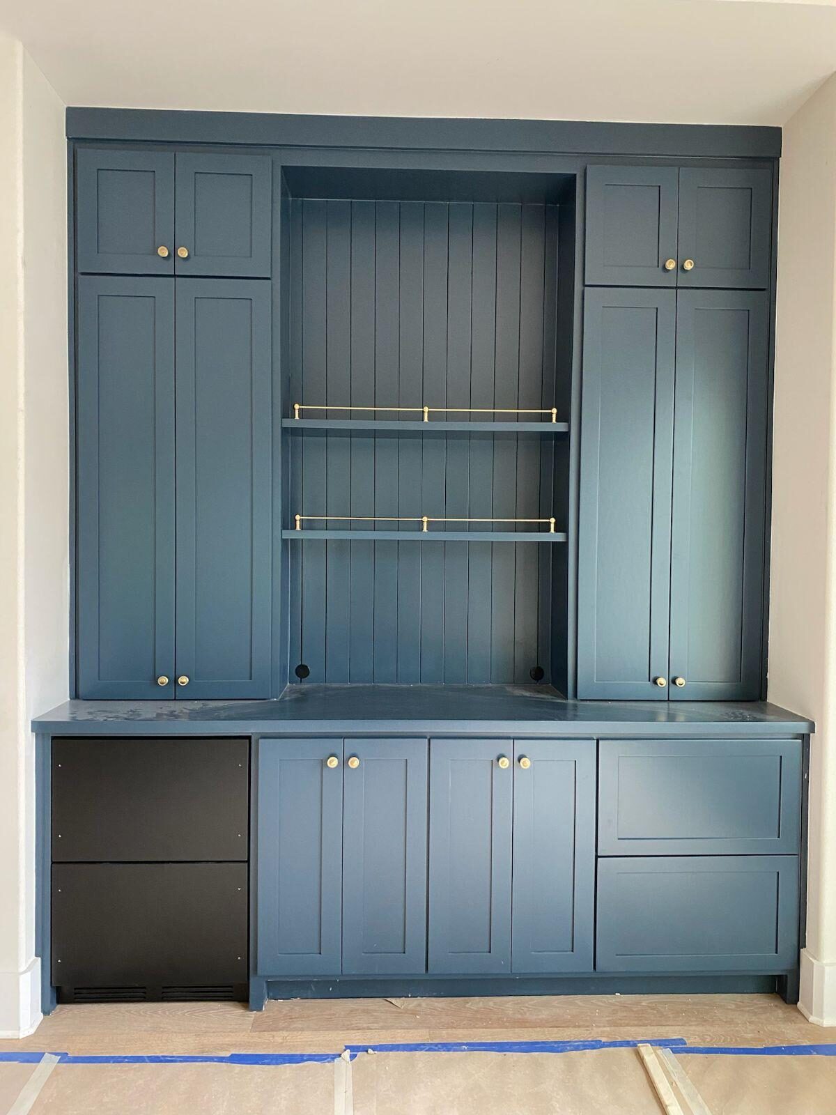 Blue built-in media cabinet with upper shelving