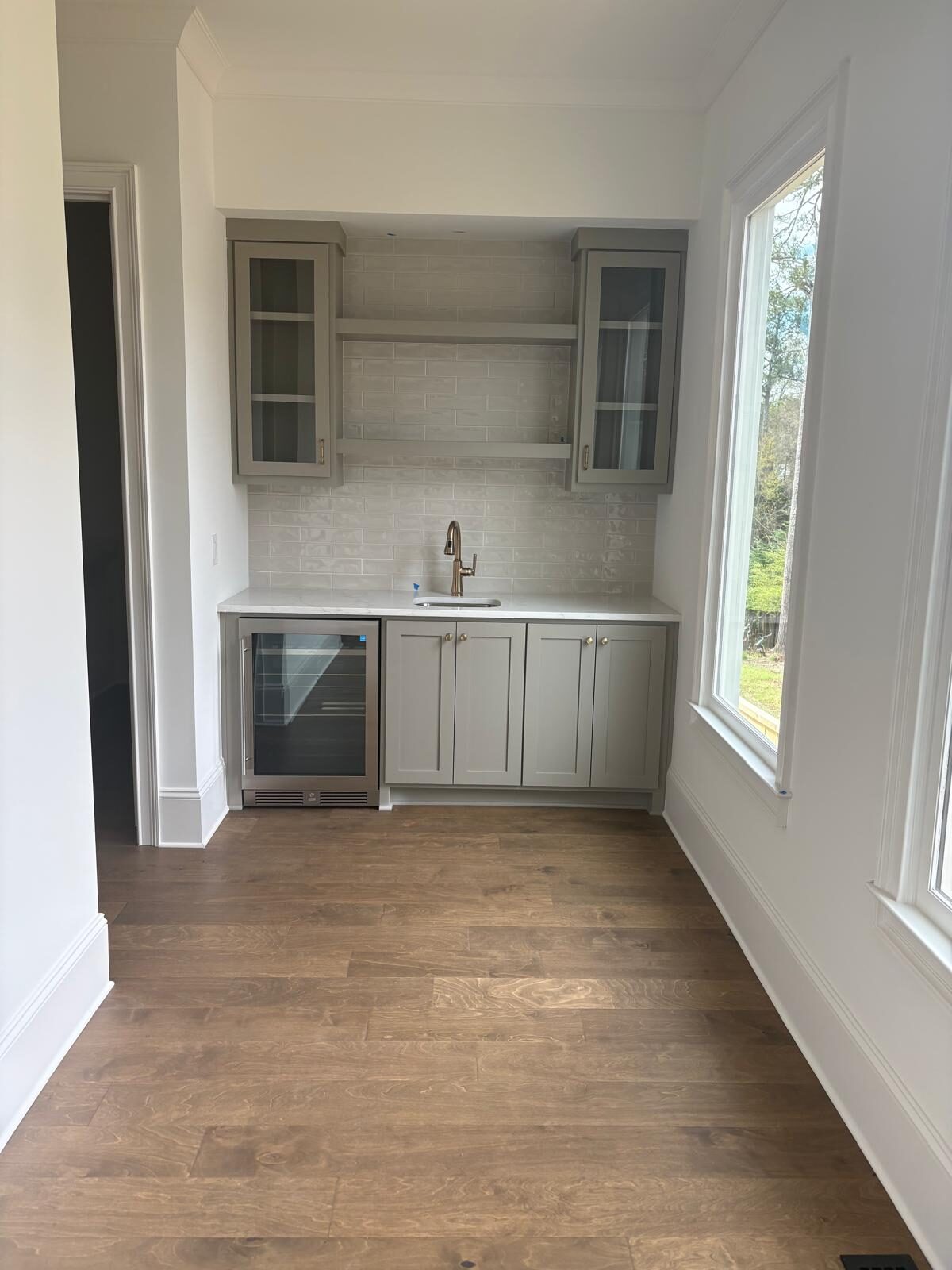 Gray butler's pantry and wet bar with upper cabinets