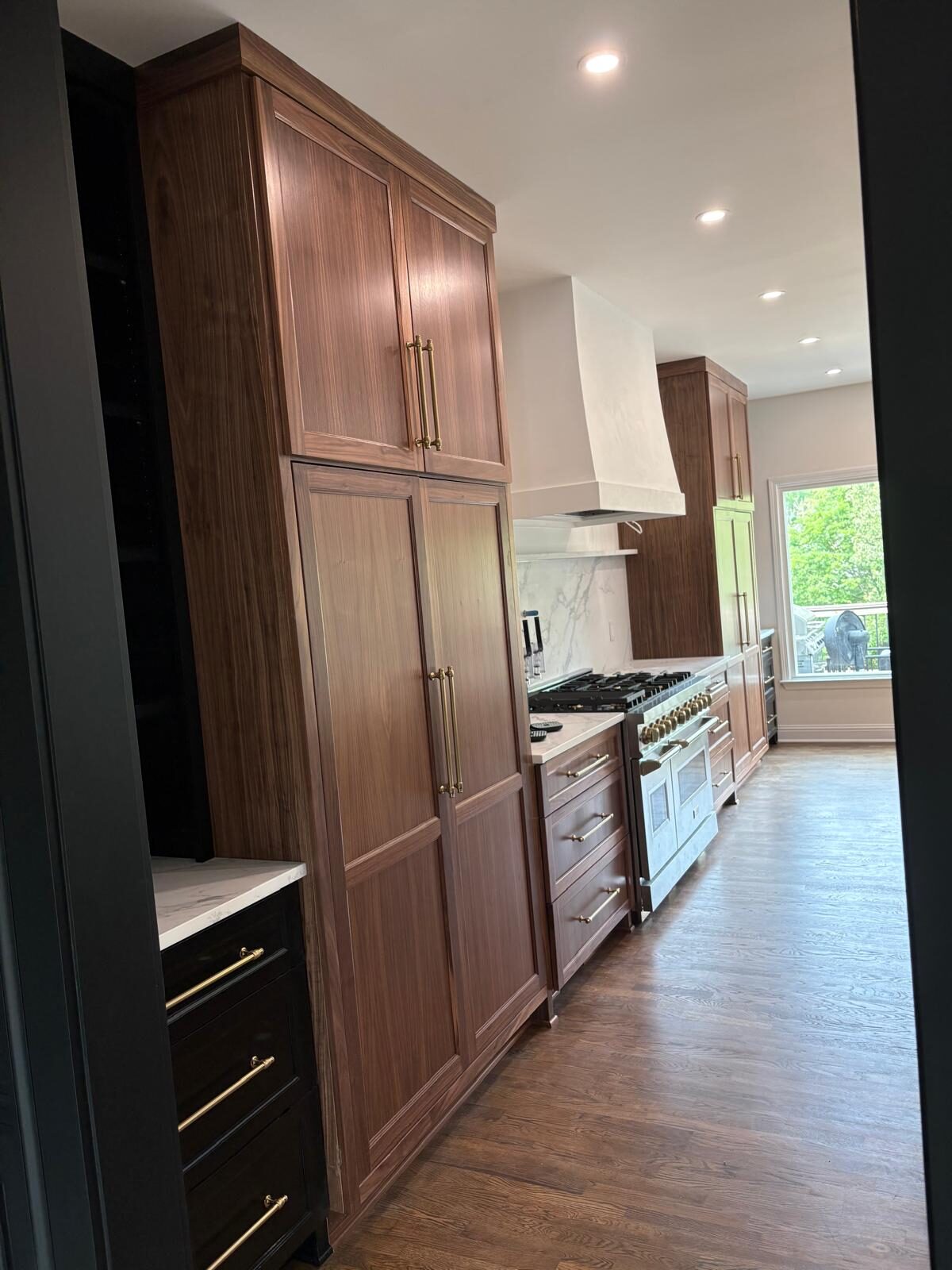 Walnut custom kitchen with a matching range hood